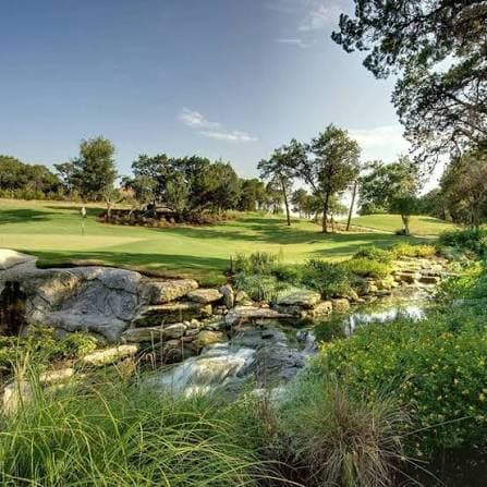 Creek crossing and live oaks at Falconhead Golf Club